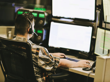 security expert monitoring building access controls