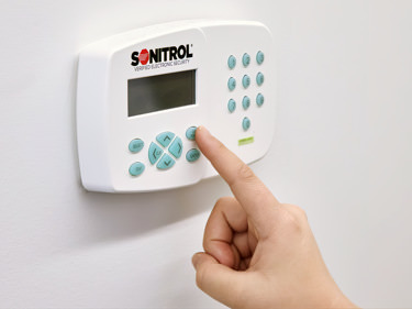 person using Sonitrol keypad control system